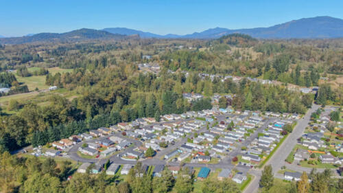 An aerial view of a rv park in a forest.