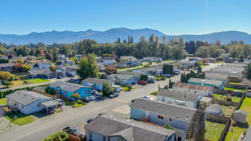 An aerial view of a residential neighborhood with mountains in the background.